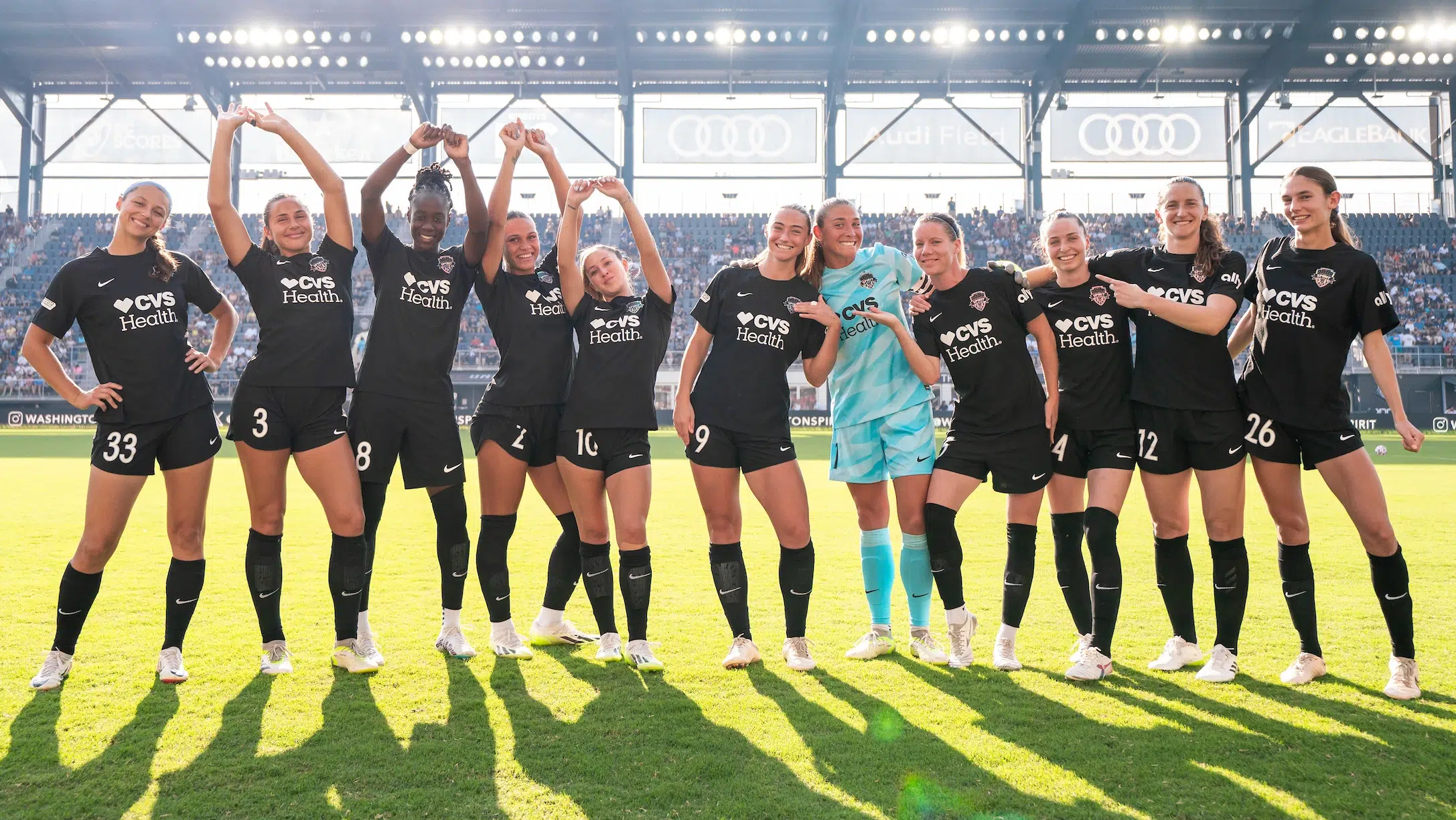 The starting eleven of the Washington Spirit in black kits pose for a photo.