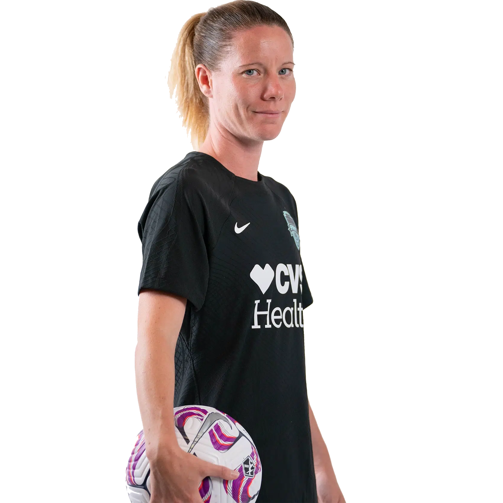 Annaig Butel holds a soccer ball in her left hand and smiles. She's wearing a black Spirit uniform with her hair in a ponytail.