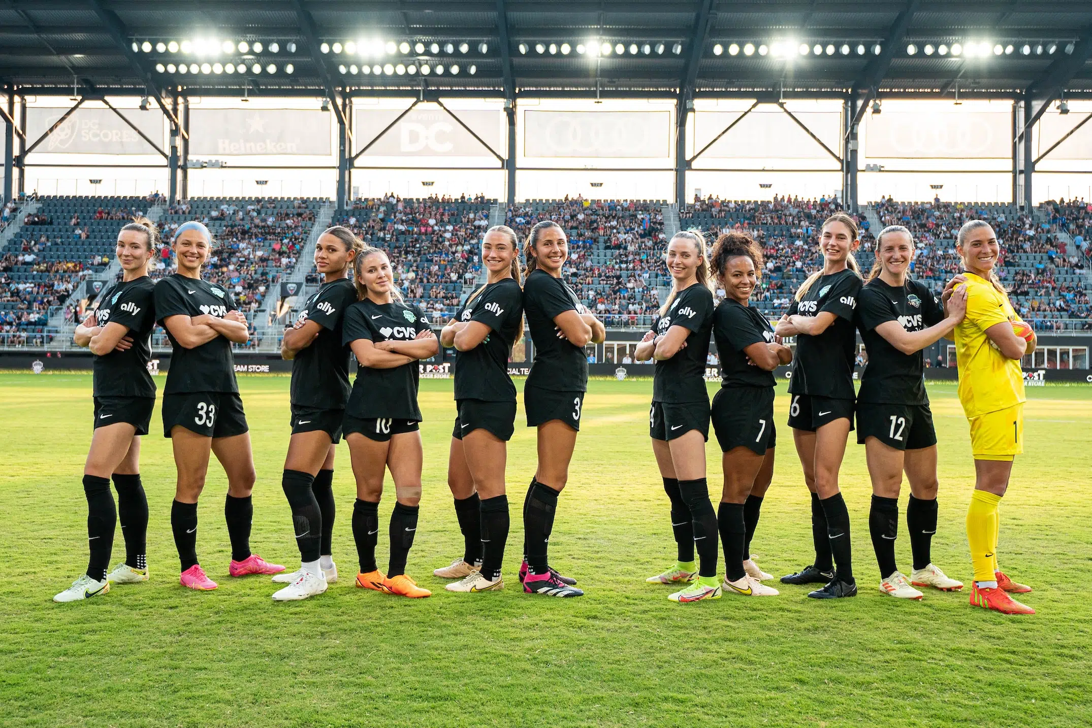 In pairs of two and three, the starting lineup for the Washington Spirit wear all black and pose back to back.