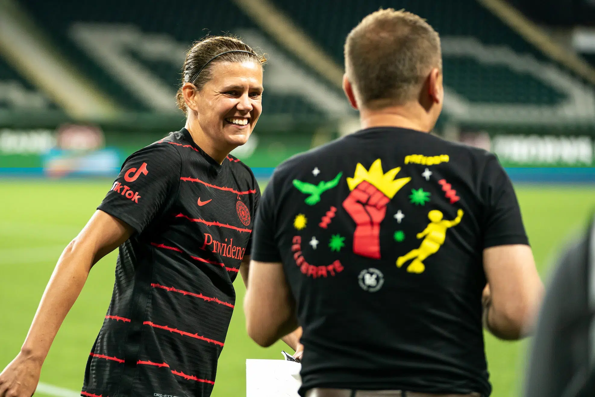 Christine Sinclair and Mark Parsons smile at each other after the game.