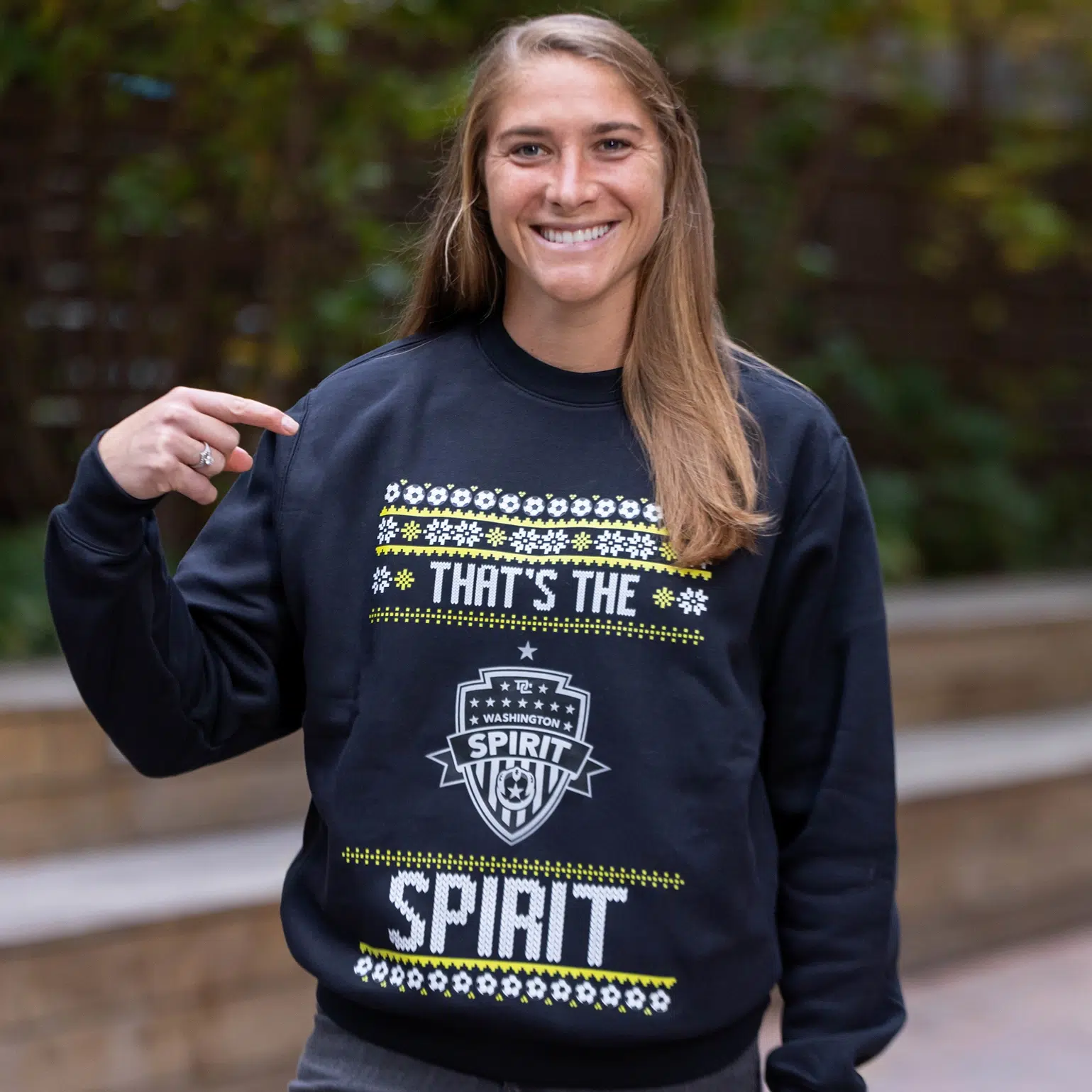 Aubrey Kingsbury wearing a black "That's the Spirit" holiday sweatshirt.