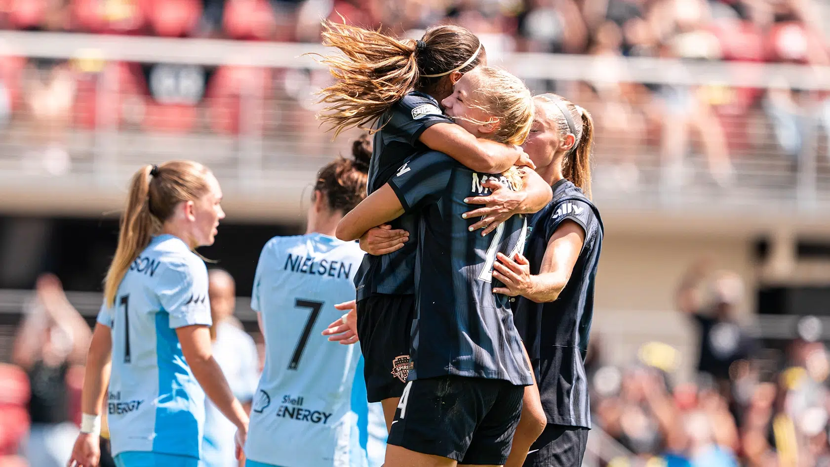 Leicy Santos jumps into the arms of Esme Morgan.