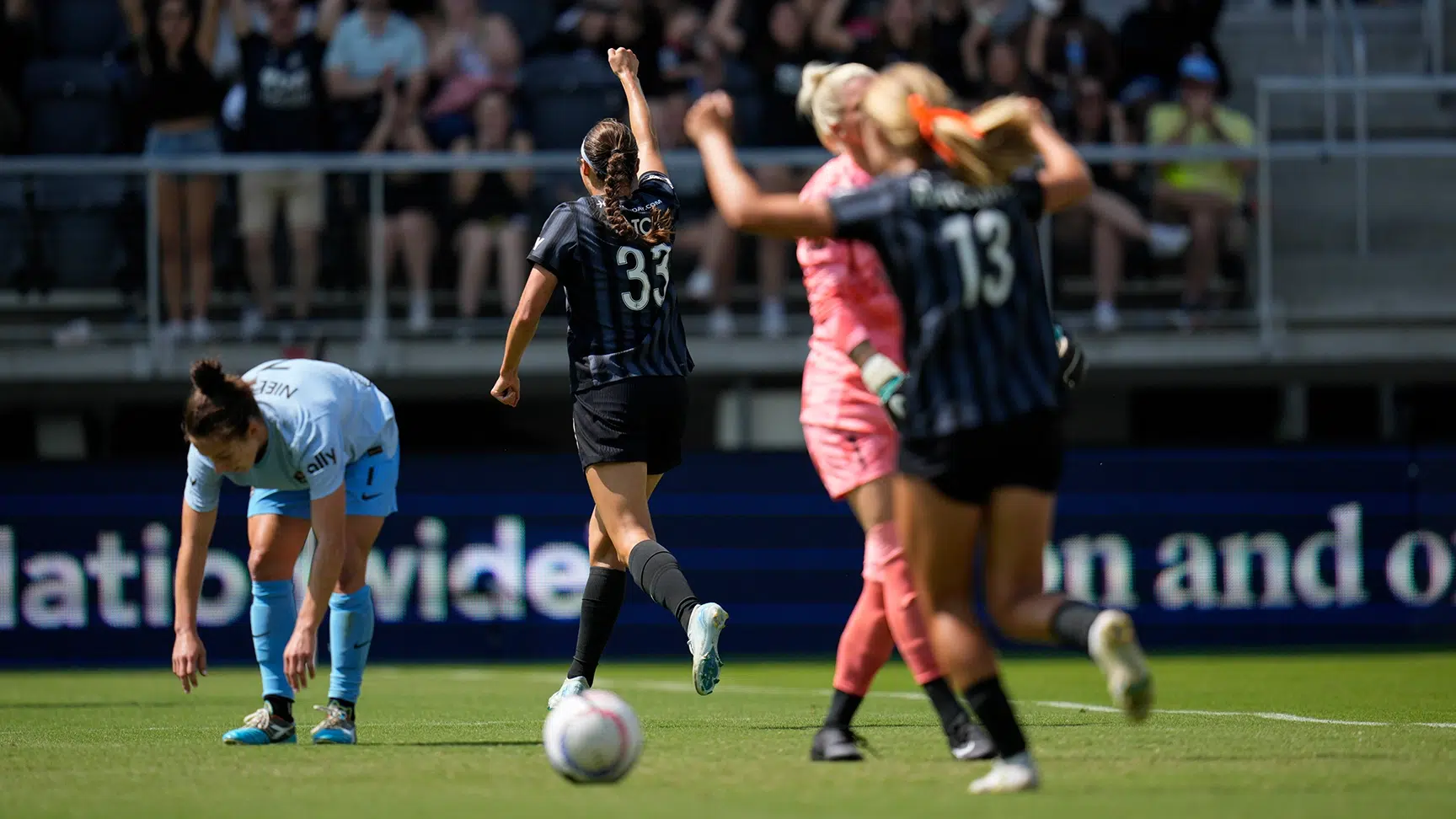 Ashley Hatch raises her fist in the air in celebration.