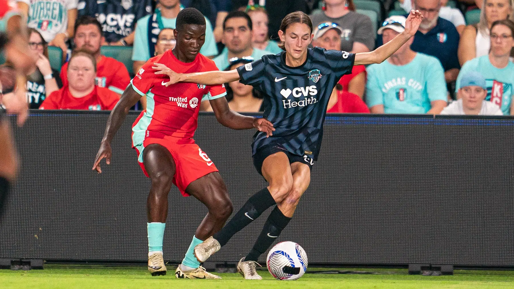 Paige Metayer dribbles the ball away from Temwa Chawinga.