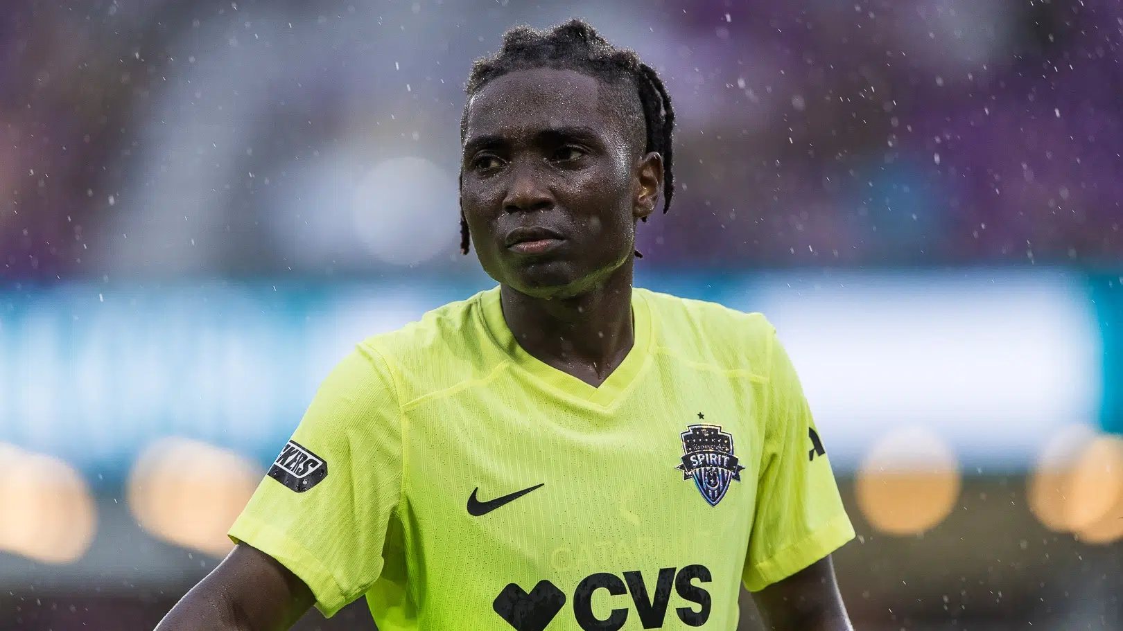 Rosemonde Kouassi in a yellow jersey in the rain.