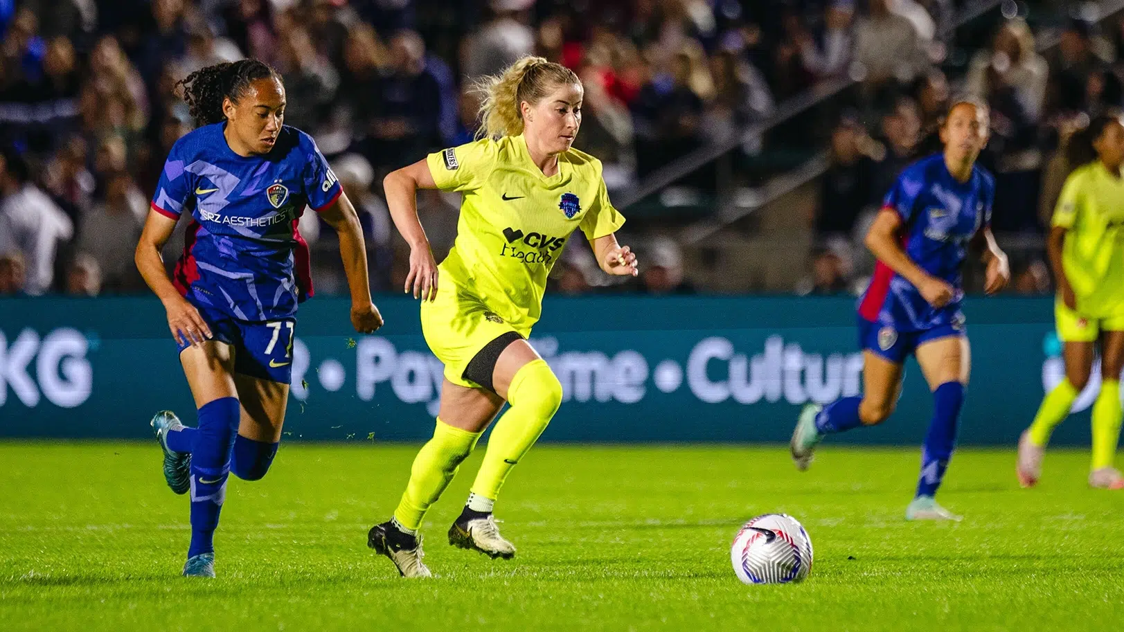 Heather Stainbrook dribbles the ball away from a defende.r