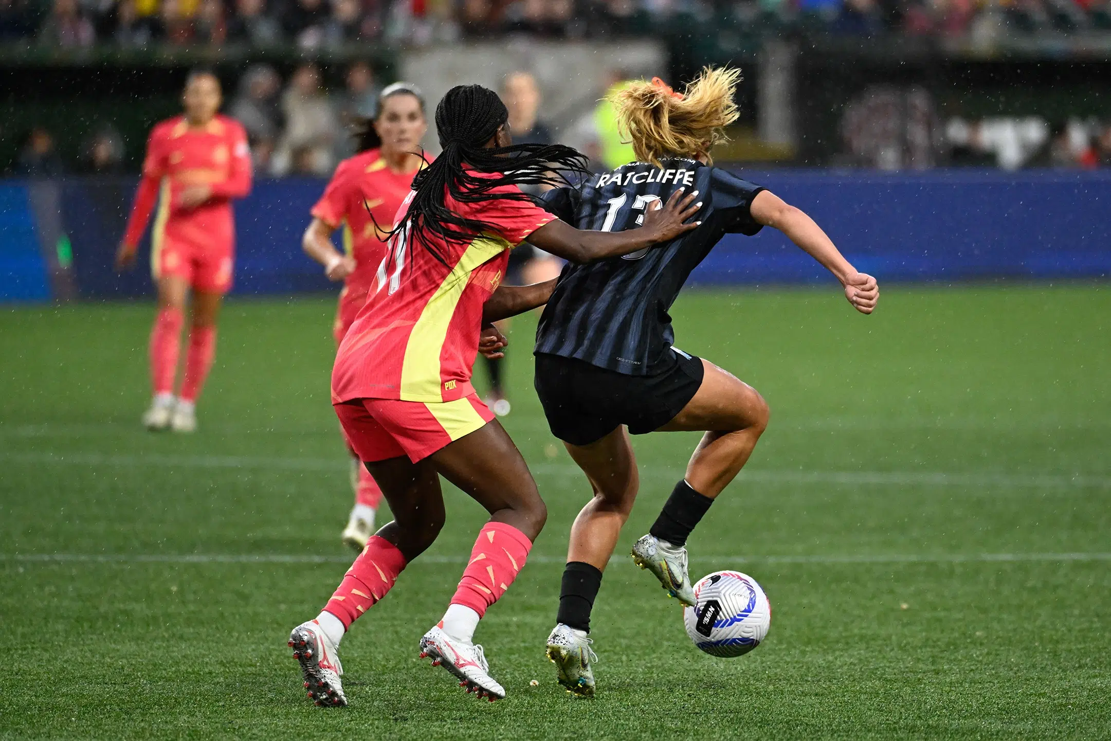 Brittany Ratcliffe shields the ball from a Thorns defender.