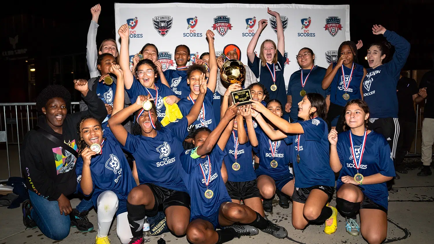 Members of the Ida B. Wells Middle School girls soccer team celebrate winning the championship.