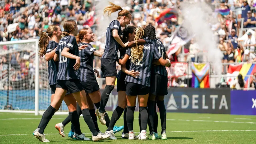 Spirit players hug in celebration.