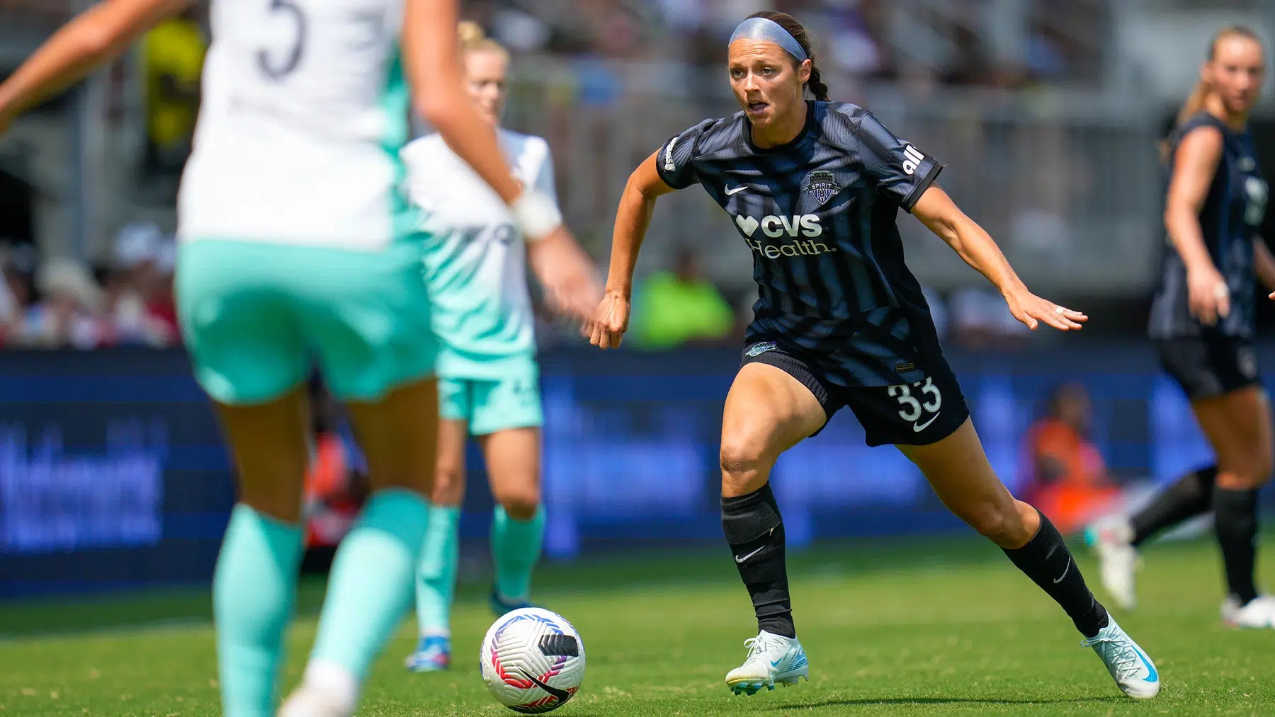 Ashley Hatch dribbles the ball.