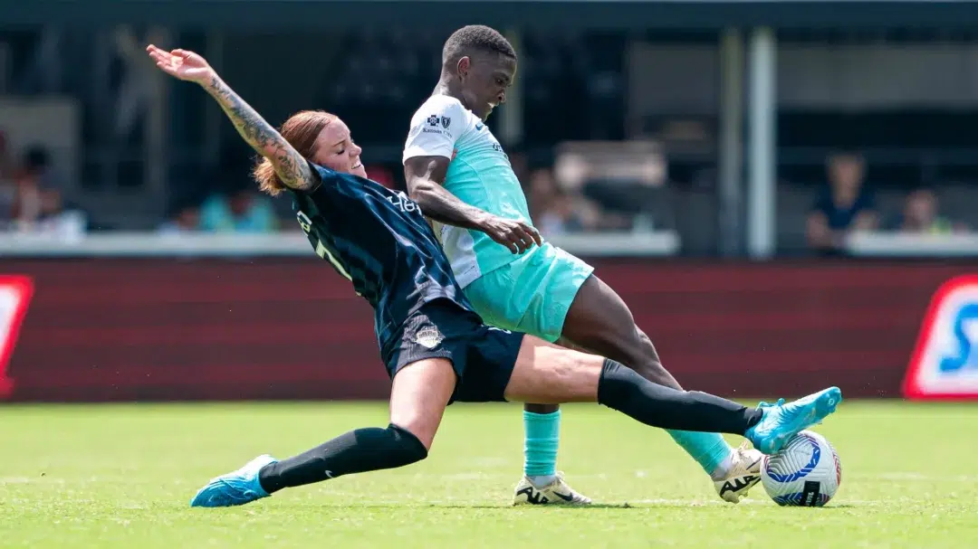 Hal Hershfelt and Temwa Chawinga battle for the ball.