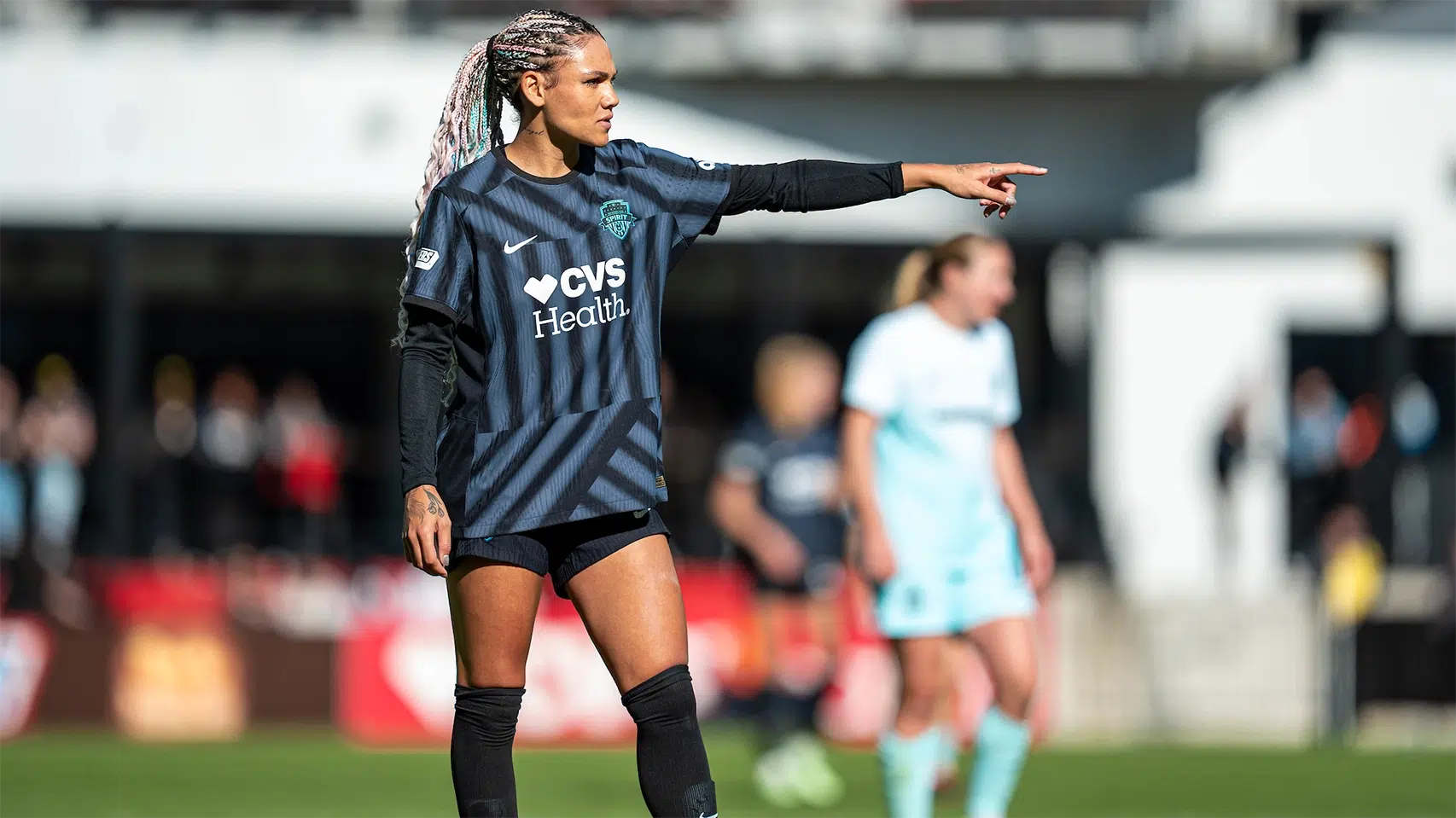 Trinity Rodman in a black Spirit uniform points her finger.