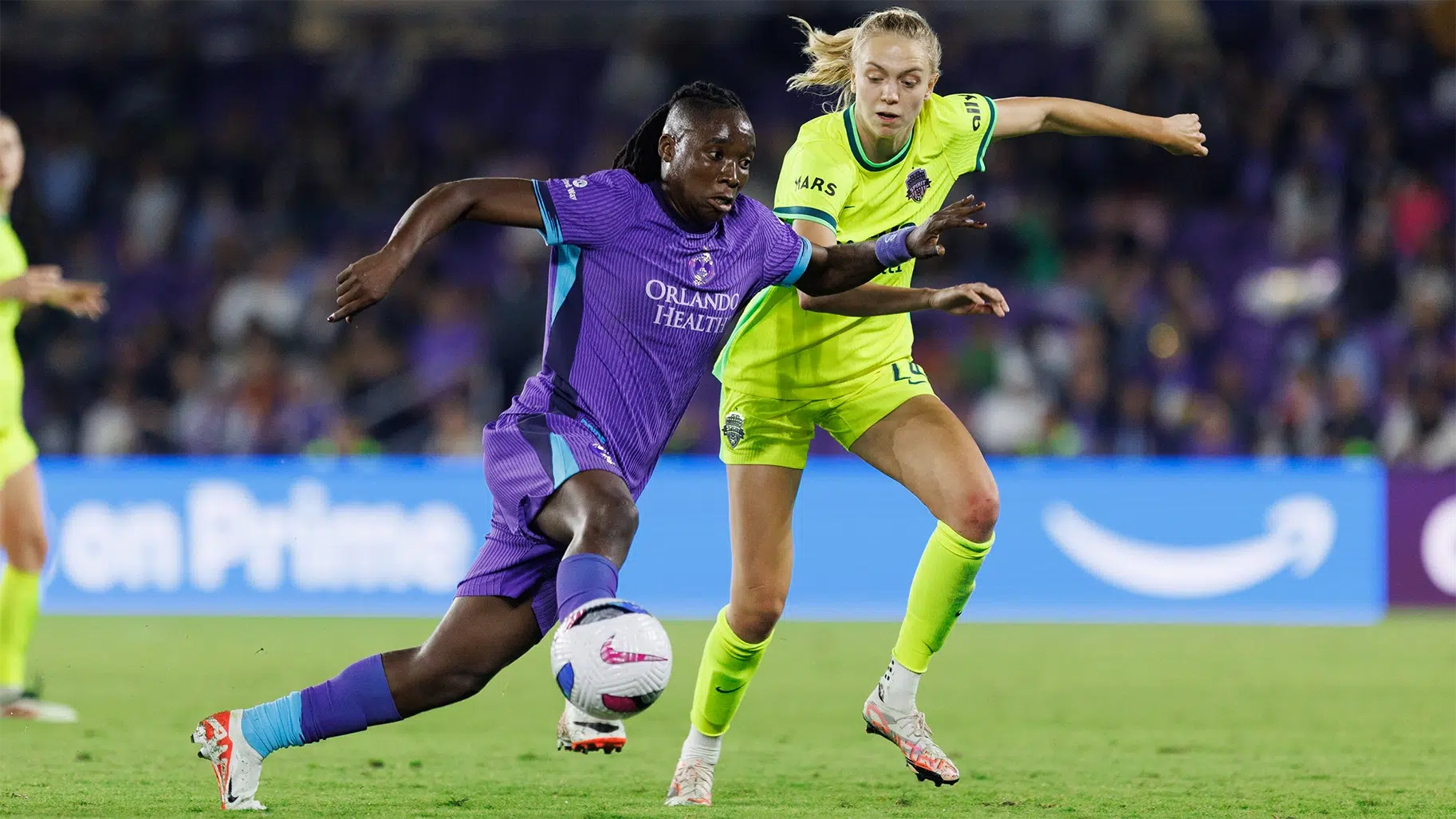 Barbra Banda and Esme Morgan battle for the ball.