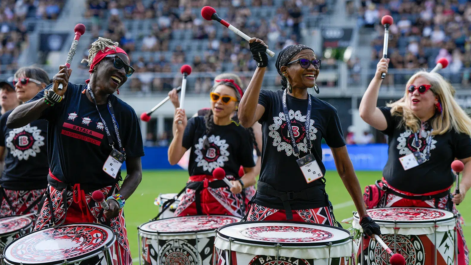 Women play drums.