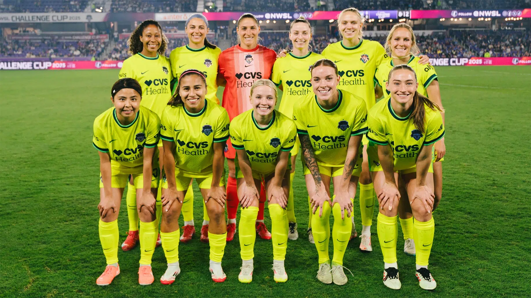 The starting eleven for the Spirit in two rows, wearing bright yellow kits.