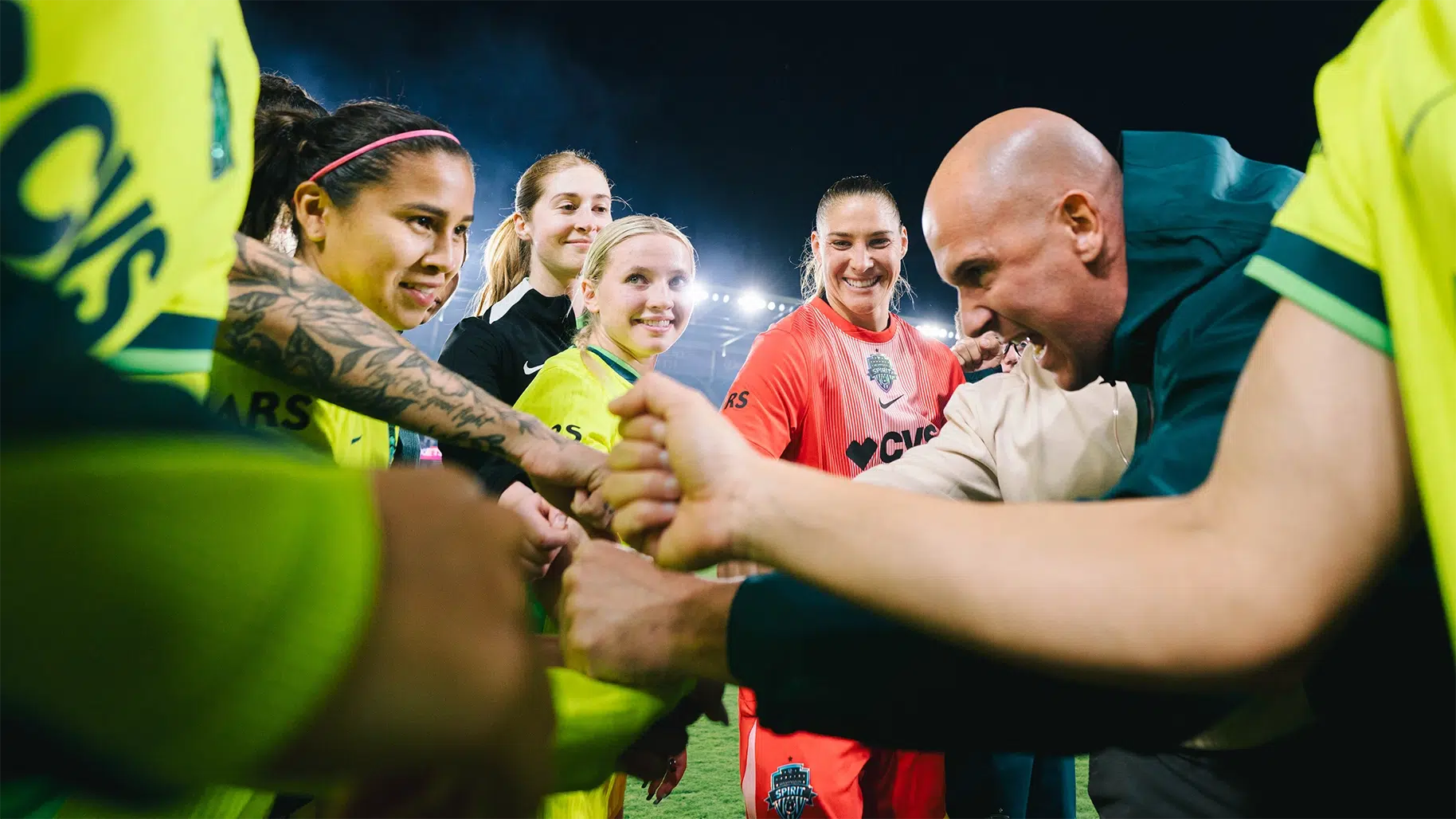 Spirit players and Adrián González huddle up before the match.